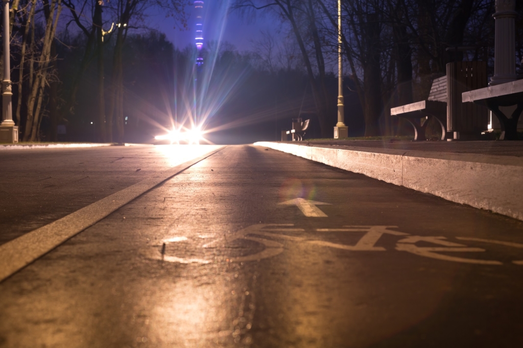 Sign bicycle path. At night in the park. this way to your health